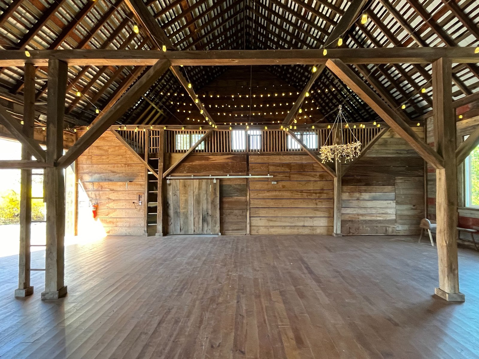 An inside view of our Homestead Barn, whose inside walls are now fully adorned with upcycled barn board.